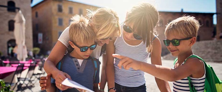 Familie schaut im Urlaub auf Stadtplan