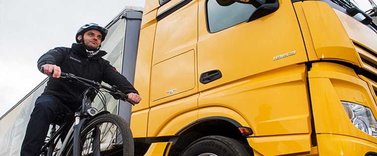 Fahrradfahrer neben LKW