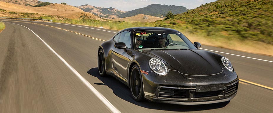 Porsche 911 fährt auf Straße.