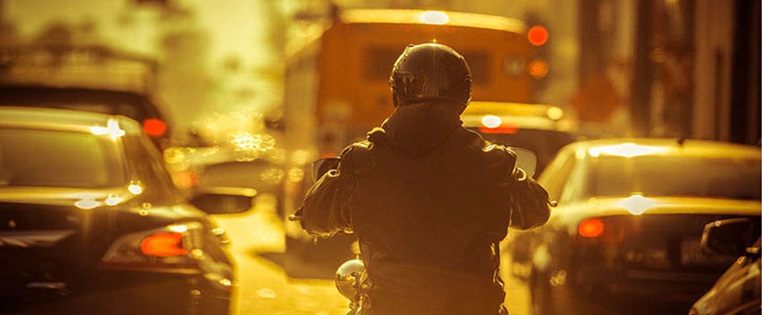 Motorradfahrer fährt durch den dichten Verkehr