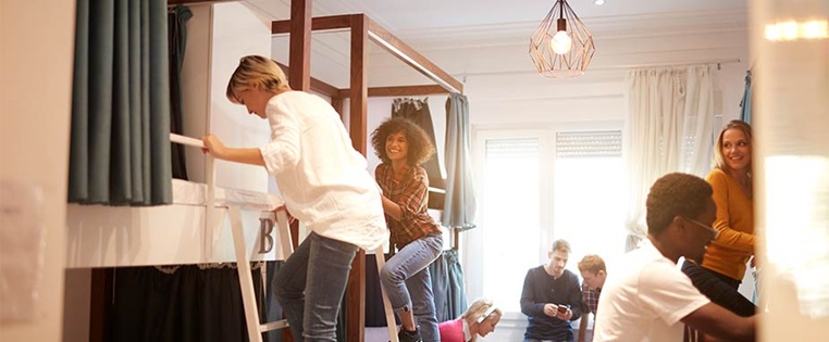 Junge Menschen beziehen ihr Hostelzimmer